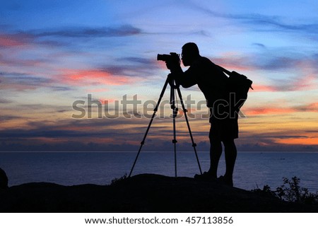 Silhouette of a young photographer during the sunrise.