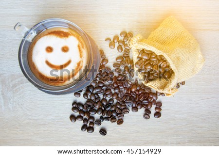 Smile Coffee wallpaper, background, grains of coffee plant and smile coffee drink on wood background.(vintage and soft tone concept)