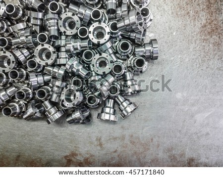 Shiny steel parts after cnc turning, drilling and machining on steel surface selective focus composition background.