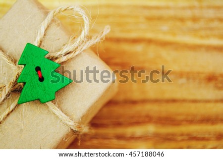 Vintage gift box (package) with blank gift tag on old wooden background.