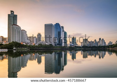 Abstract city reflection river on sunrise. Panoramic and perspective wide angle view to steel light blue background of glass high rise building skyscraper commercial modern city of future.pastel tone.