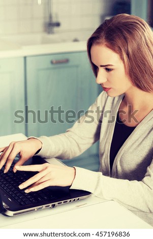 Beautiful caucasian woman working on laptop.