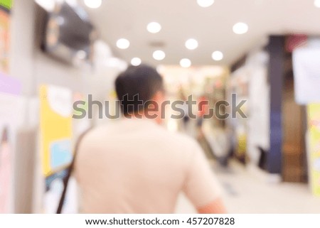Blur image of shopping mall and people .