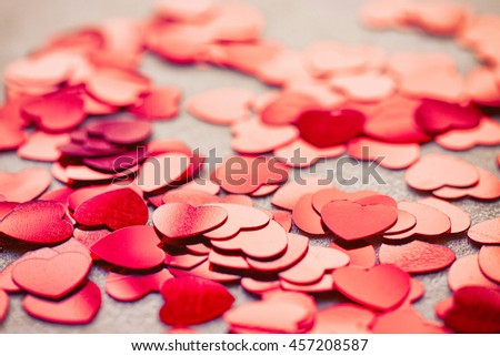 valentine's day background with shiny confetti heart shape, macro photo, selective focus