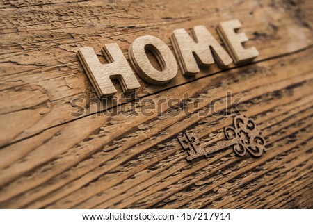 home security concept - old key sign. Word made from wooden letters. objects lie on wooden table.