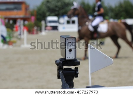 Starting timekeeper at show jumping competition, starting line with the timer 