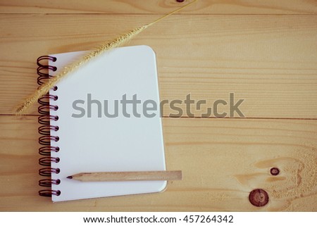 notebook and pencil  on wooden