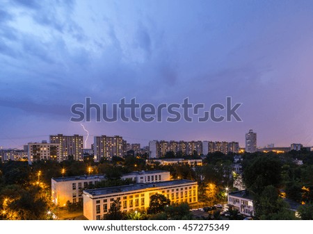 Flash of lightning over the city in the evening sky