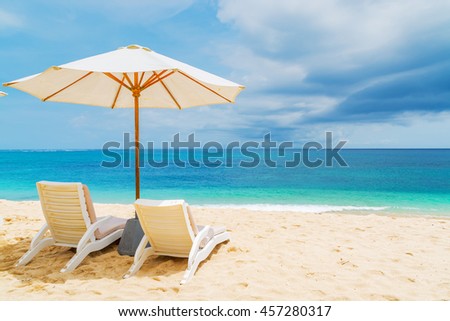 Sunshade and outdoor lounger at a tropical resort in Asia Royalty-Free Stock Photo #457280317