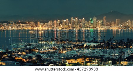 San Diego downtown skyline at night with boat in harbor.