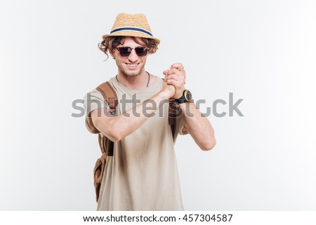 Young smiling stylish man showing well done gesture over white background