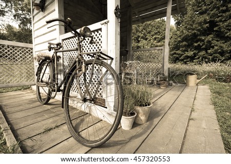 Old retro vintage bicycle on vintage wooden house wall