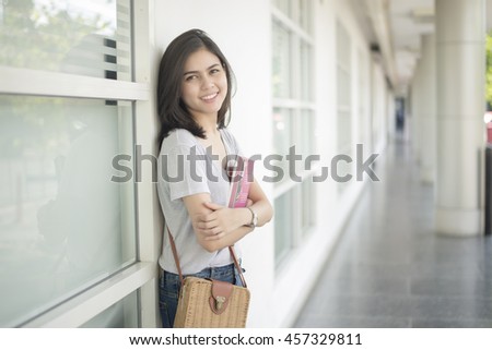 A portrait of an Asian university student on campus