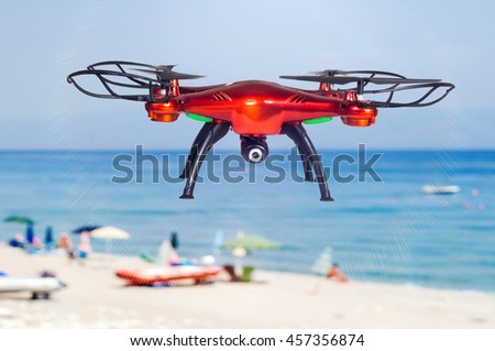 Small Red drone flying on the beach of Letojanni, Sicily