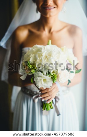 bride with white flowers looking at camera