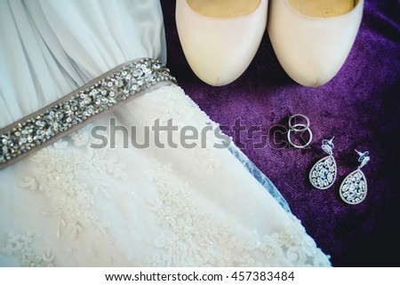 beautiful accessories and shoes lying on the bed Royalty-Free Stock Photo #457383484