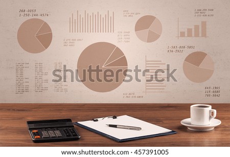 Graphic business office desk with pie charts and graphs on the brown sepia background wall