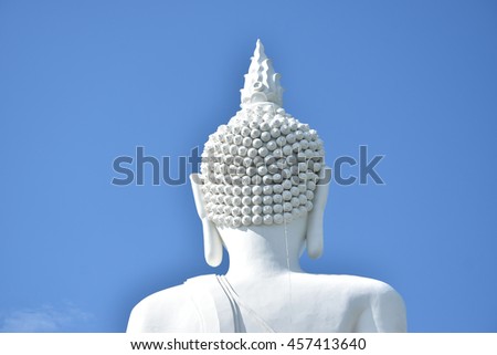 The back side of  white Buddha  statue,with blue sky and cloud background