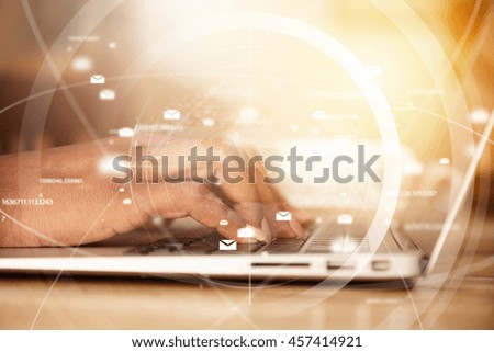 Double exposure of African female student keyboarding on generic laptop, posting new photos via social networks while sitting at a coffee shop. Woman's hands typing a message via e-mail. Film effect.