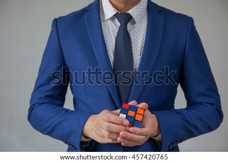 Businessman solving cubic problems - problem solution and making strategic moves concept.