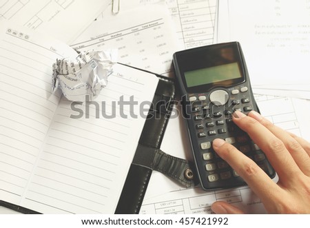 Close up of man with calculator counting making notes in the crisis at desk office.