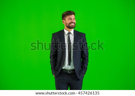 The businessman stand on the green background