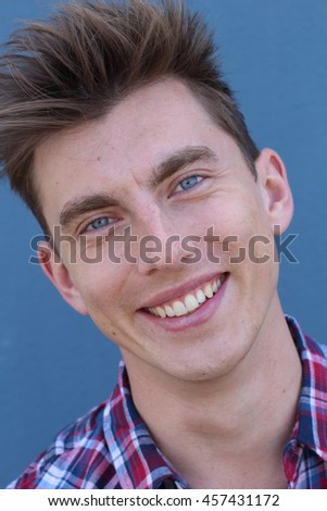 Blonde handsome man with blue eyes on blue background