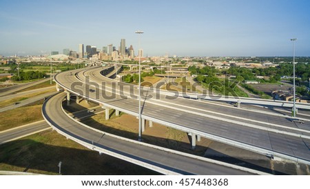 Panorama aerial view Houston downtown and interstate 69 highway with massive intersection, stack interchange and elevated road junction overpass at early morning from the northeast side of Houston, US
