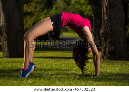 girl engaged in yoga, gymnastics, fitness outdoors.