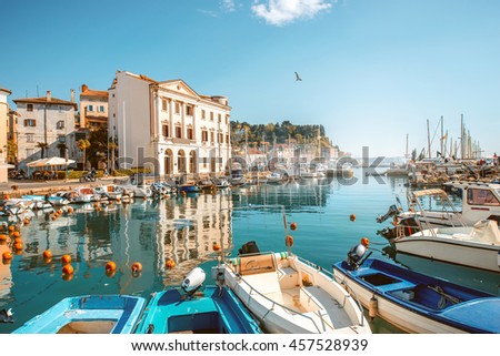 View on marina with boats and buoys in Piran town in southwestern Slovenia Royalty-Free Stock Photo #457528939