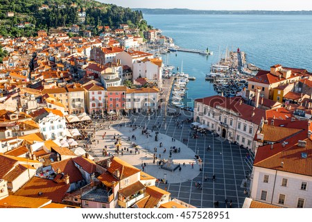 Beautiful aerial view on Piran town with Tartini main square, ancient buildings with red roofs and Adriatic sea in southwestern Slovenia Royalty-Free Stock Photo #457528951