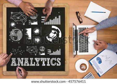 ANALYTICS (Analysis Analytic Marketing  Graph Diagram) Businessman working at office desk and using computer and objects on the right, coffee,  top view,