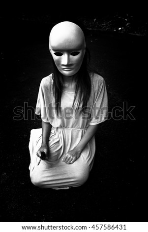 Dark doctrine,Mysterious woman wearing white mask,Scary background for book cover