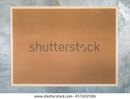 Blank Cork board with wooden frame stone wall
