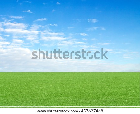 football field blue sky with clouds