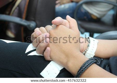 The close up shot of couple hand holding together concept of secret love, care, encourage and relationship
