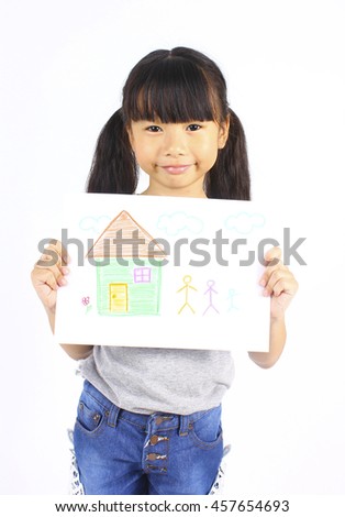 Closeup portrait of Asian little girl holding her art work. drawing a house and family member with crayons.