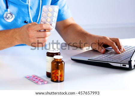the doctor writes a prescription pill on the computer