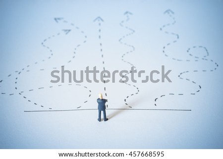 Business decision concept. Businessman standing confusing with arrow pathway choice. 
