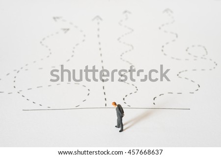 Business decision concept. Businessman standing confusing with arrow pathway choice. 