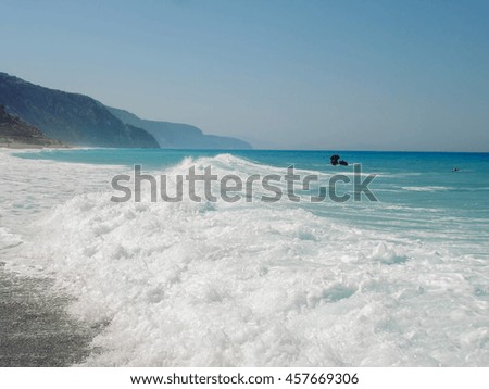 Wild Beach On Lefkada Island In Greece, Water Crashing On The Rocks In The Background On Lefkada Island 

