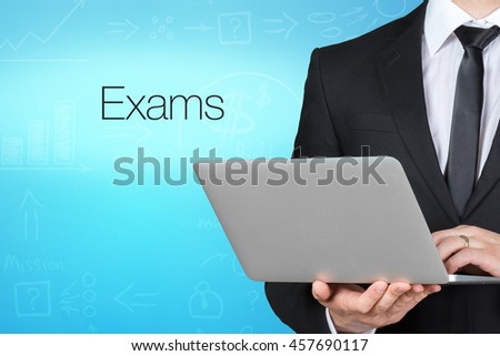 Unrecognizable businessman with laptop standing near text - exams