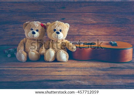 teddy bear with Ukulele on wood background,music and valentine concept,vintage style