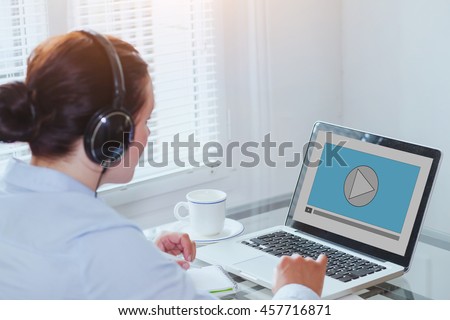 woman watching video tutorial on computer, business education online, multimedia