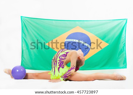 Girl doing rhythmic gymnastics element use ball, split. Compete in individual events. Brazilian flag at the white background. Brazil fan support. Gymnastics program