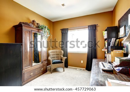 Office room interior with antique wardrobe, wicker chair and desk