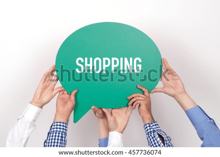 Group of people holding the SHOPPING written speech bubble