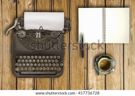 Vintage typewriter and coffee on wood background
