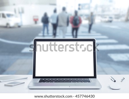 Laptop computer with blurred image of business people background
