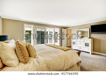 Master bedroom in American style. Furnished with Double bed and White vanity cabinet with mirror. View of the balcony